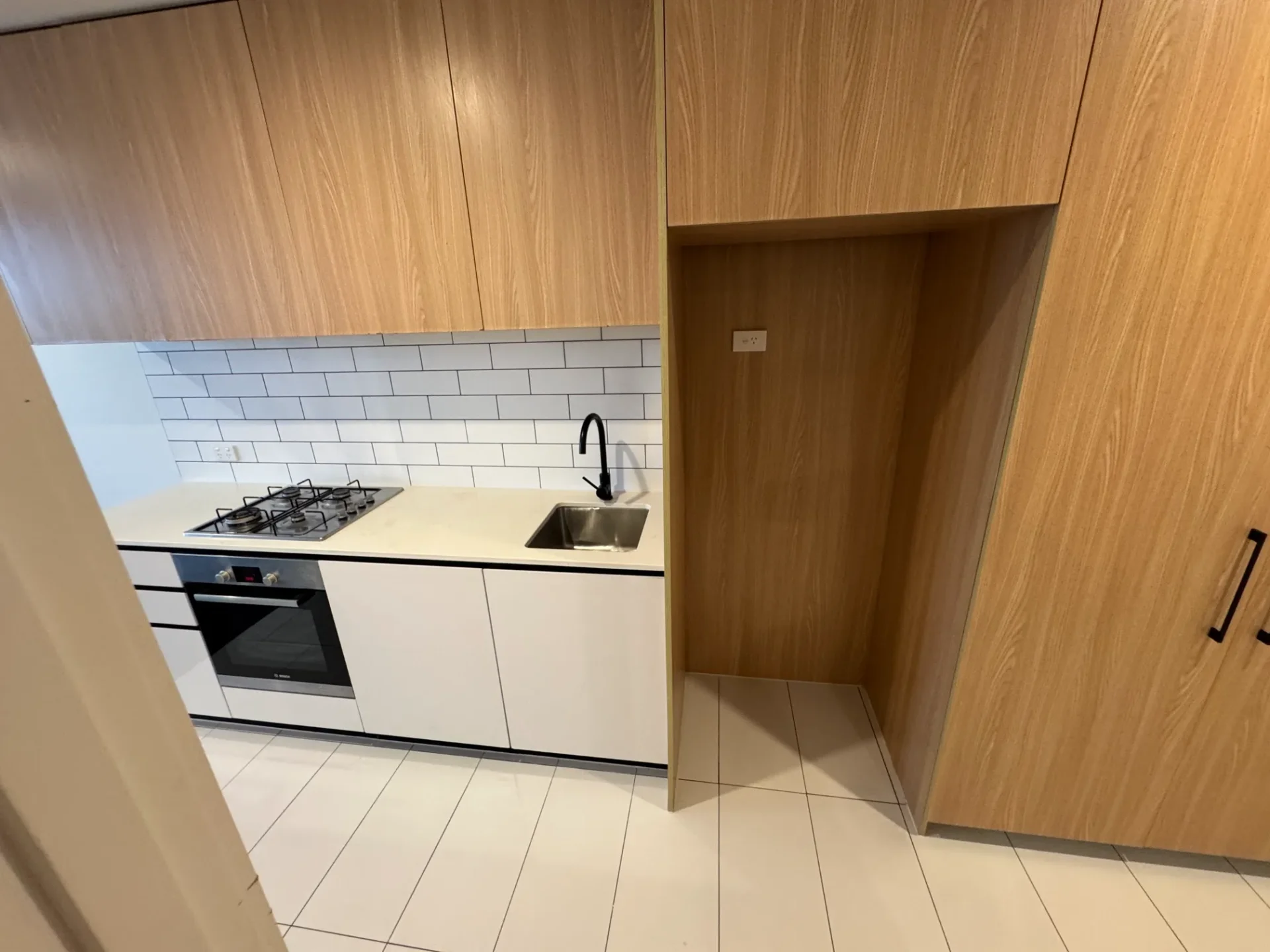 Kitchen renovation with modern appliances and white subway tiles