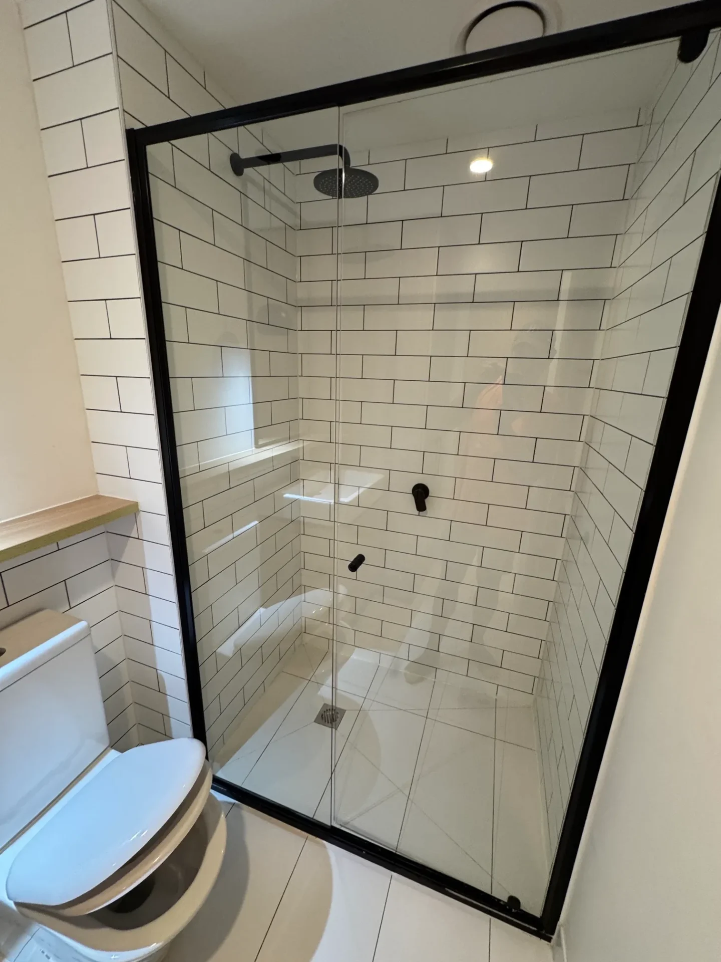 Bathroom renovation with black framed shower screen